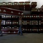 Workers carry a coffin in a caskets factory in Caracas