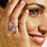 A model displays the 'Pink Star' 59.60 carat oval cut pink diamond at Sotheby's in Geneva