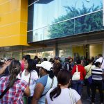 Shoppers crowd outside a Daka store as they wait to shop for electronic goods in Caracas