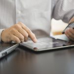 USA, New Jersey, Jersey City, Man using tablet pc, laptop and smartphone