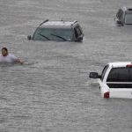 Jesus Rodriguez rescues Gloria Garcia after rain from Hurricane Harvey flooded Pearland, in the outskirts of Houston