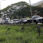 People with vehicles wait in line in an attempt to refuel at a gas station in Valencia
