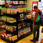 People shop inside a convenience store at a five-star hotel in Caracas