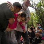 Asylum-seeking migrants cross the Rio Grande river in Del Rio