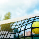 Close-up view of tennis ball in net